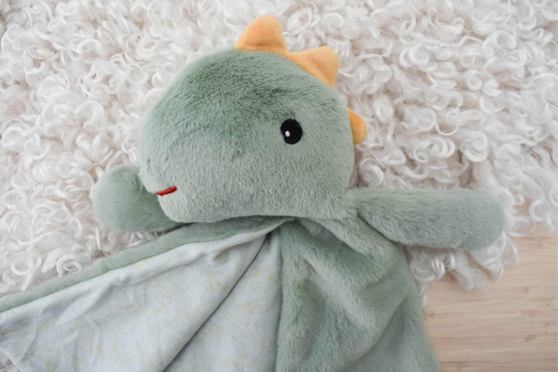 Snuggle buddy minty dinosaur blanket